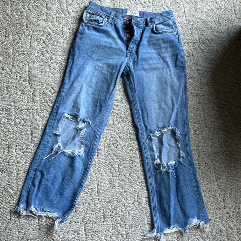 Free People Jeans size 26. Medium to low rise with holes on the knee